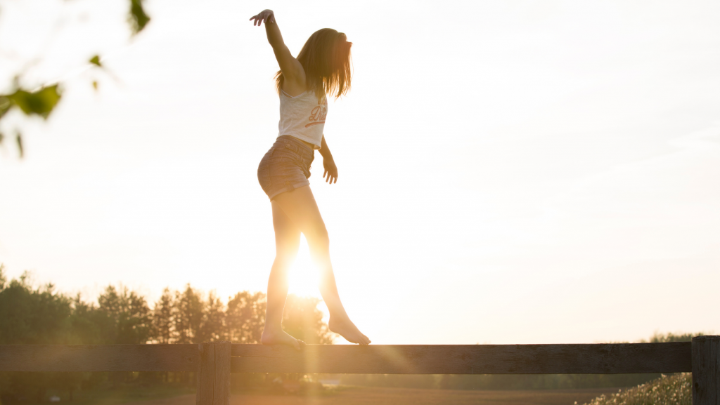 Woman balancing in sunlight